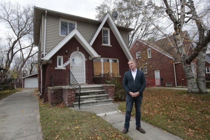 Amsterdam based investor Edwin Schouten, stands outside a house he is brokering as an investment in Detroit, Michigan November 19, 2015. REUTERS