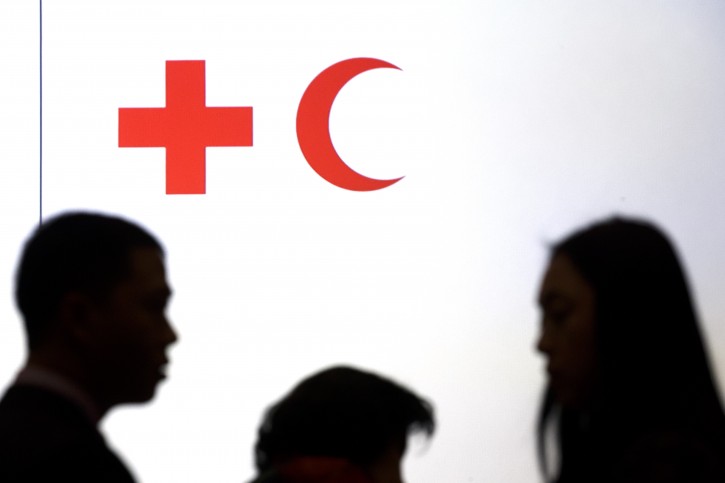 Delegates speak together in the assembly hall, prior the opening ceremony of the 20. Session of  The International Federation of Red Cross and Red Crescent Societies   IFRC, in Geneva, Switzerland, Friday, Dec. 4, 2015.  (Salvatore Di Nolfi/Keystone via AP)