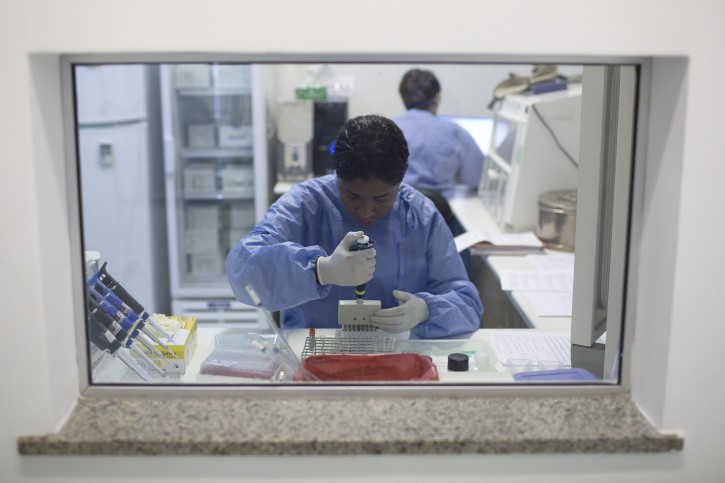 A graduate student works on analyzing samples to identify the Zika virus in a laboratory at the Fiocruz institute in Rio de Janeiro, Brazil, Friday, Jan. 22, 2016. Health officials say they're trying to determine if an unusual jump in cases of a rare nerve condition sometimes severe enough to cause paralysis is related to the spread of the mosquito-borne Zika virus in at least two Latin American countries. (AP Photo/Leo Correa)