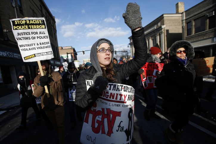 Activists calling for economic and racial justice march in Boston on Martin Luther King Jr. Day, Monday, Jan. 18, 2016. (AP Photo/Michael Dwyer)