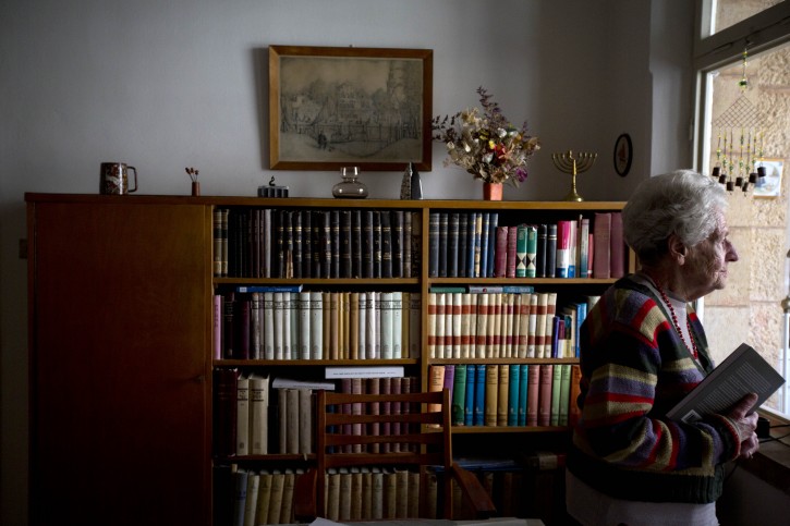In this Jan. 20, 2016, photo, Dutch Israeli holocaust survivor Mirjam Bolle looks out of the window in her house in Jerusalem. Throughout the Nazi occupation of Amsterdam, and while incarcerated in two prison camps, Bolle wrote letters to her fiance that she never sent but hoped to share with him after the war. Yet when the two ultimately reunited she decided to leave the past behind and stashed them away. Now, decades later, she has published them as a memoir. (AP Photo/Sebastian Scheiner)