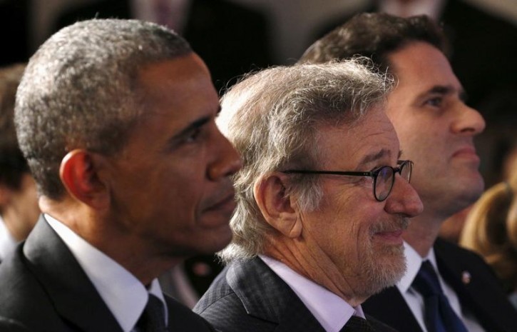 U.S. President Barack Obama, seated beside Steven Spielberg (C) and Israeli Ambassador to the U.S. Ron Dermer (R) listen to remarks at the Righteous Among the Nations Award Ceremony, organised for the first time in the U.S. by Yad Vashem, at the Embassy of Israel in Washington January 27, 2016. REUTERS/Kevin Lamarque