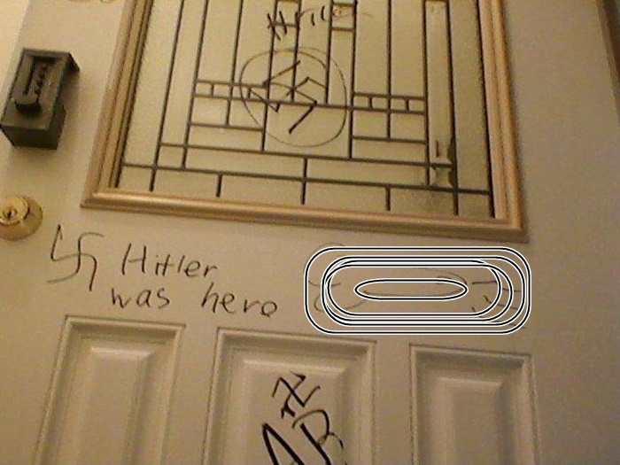 Part of the Graffiti scribbled at the home. vulgar drawing in photo has been blurred out.