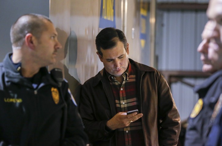 FILE - US Republican presidential candidate and Texas Senator, Ted Cruz (C) looks at his mobile phone before a campaign event in Kennesaw, Georgia, USA, 18 December 2015. EPA