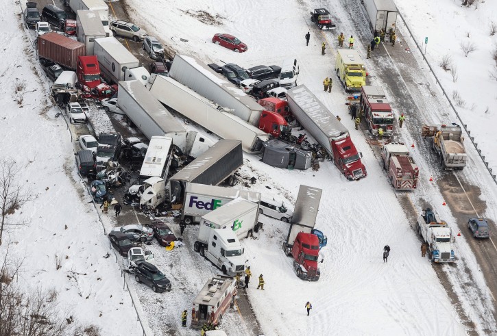 Vehicles pile up at the site of a fatal crash near Fredericksburg, Pa., Saturday, Feb. 13, 2016. The pileup left tractor-trailers, box trucks and cars tangled together across several lanes of traffic and into the snow-covered median. (James Robinson/PennLive.com via AP) 