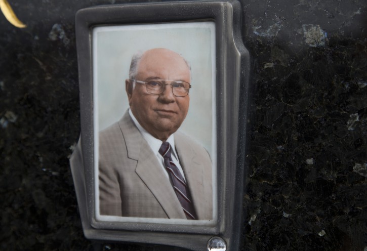 This July 28, 2014, photo shows Jakob Denzinger's portrait on the tombstone of his empty grave in Cepin, eastern Croatia.  The suspected former Nazi prison guard at Auschwitz and other death camps, Jakob Denzinger, has died in his native Croatia at the age of 92. (AP Photo/Darko Bandic)