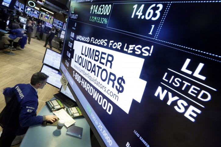 Specialist Anthony Rinaldi works on the trading floor of the New York Stock Exchange, adjacent to the post that handles Lumber Liquidators, Monday, Feb. 1, 2016. (AP Photo/Richard Drew)