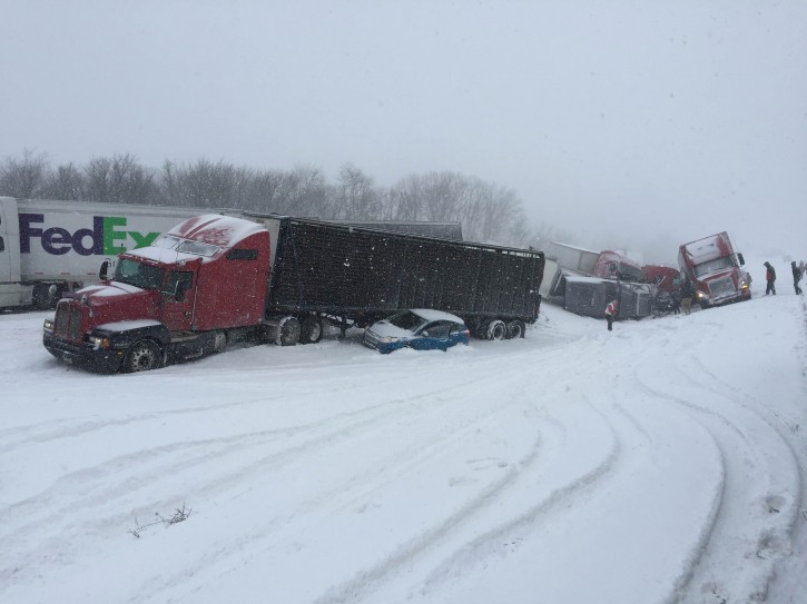 Vehicles pile up at the site of a fatal crash near Fredericksburg, Pa., Saturday, Feb. 13, 2016. The pileup left tractor-trailers, box trucks and cars tangled together across several lanes of traffic and into the snow-covered median. (Cooper Leslie via AP)