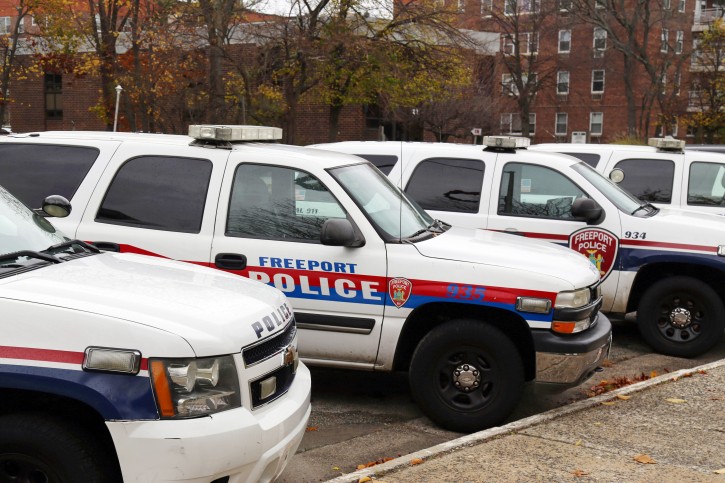 In this Nov. 19, 2015, photo, police department vehicles are lined up outside of Village Hall in Freeport, N.Y. Each computer-equipped vehicle receives data from license plate scanners positioned around the village. The data influx has increased the departments workload and has caught the attention of civil libertarians. (AP Photo/Michael Balsamo)