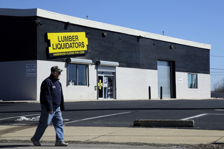 FILE - In this March 12, 2015 file photo, a man walks past a Lumber Liquidators store in Philadelphia. Lumber Liquidators' stock plunged Monday, Feb. 22, 2016, as the Centers for Disease Control and Prevention now says people exposed to certain types of the company's laminate flooring were three times more likely to get cancer than the agency previously predicted. (AP Photo/Matt Slocum)