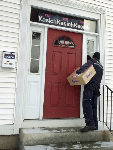 A FedEx driver attempts to deliver a package to the closed John Kasich campaign office in Manchester, N.H., on Wednesday, Feb. 10, 2016, the morning after the nation's first presidential primary. New Hampshire has only four electoral college votes, but its status as a swing state means whichever candidates end up as nominees likely will return. (AP Photo/Jim Cole)