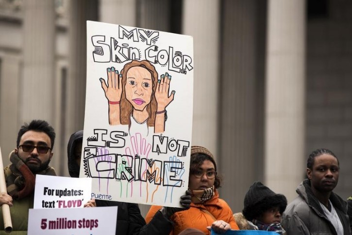 FILE - Demonstrators hold signs protesting the New York Police Department's "stop and frisk" crime-fighting tactic outside of Manhattan Federal Court in New York, March 18, 2013. Reuters