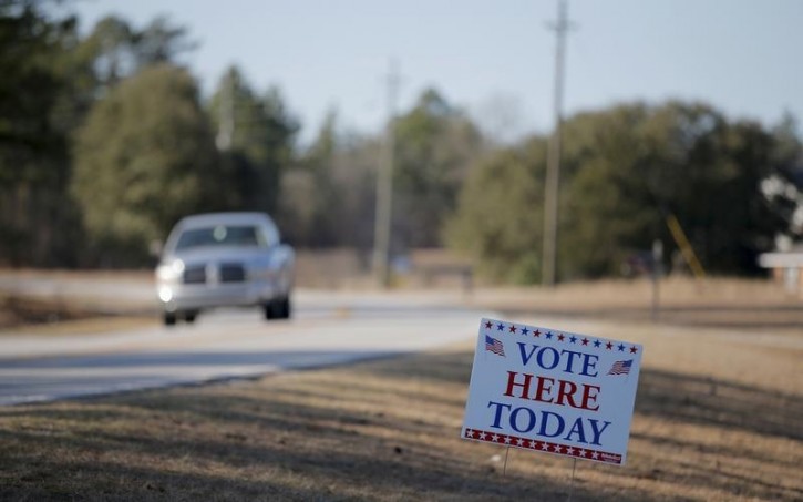 A vehicle drives down the road past a polling place during the U.S. Democratic presidential primary election in Kershaw, South Carolina February 27, 2016. REUTERS/Chris Keane