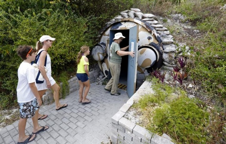 FILE -Guests, led by curator Ruth Pelletier (R), enter the cold-war era nuclear fallout shelter constructed for U.S. President John F. Kennedy on Peanut Island near Riviera Beach, Florida November 8, 2013. Reuters