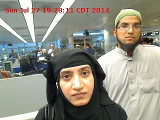 FILE - Tashfeen Malik, (L), and Syed Farook are pictured passing through Chicago's O'Hare International Airport in this July 27, 2014 handout photo obtained by Reuters December 8, 2015.  