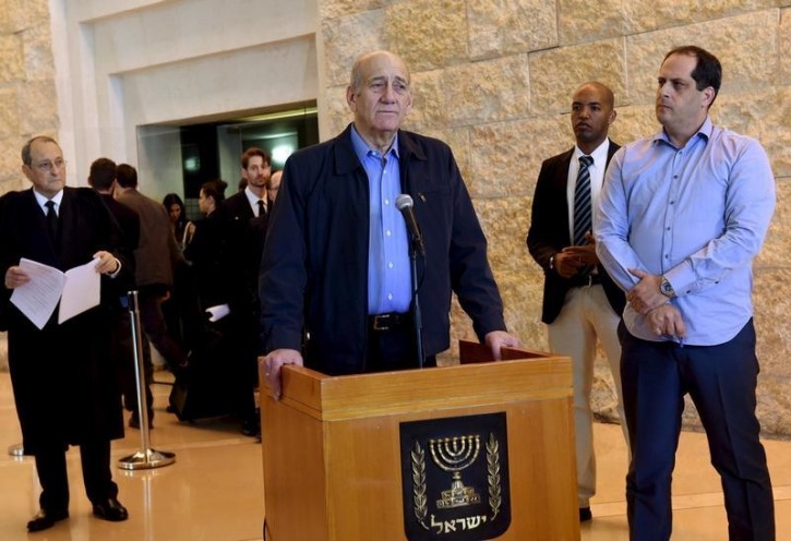 FILE - Former Israeli Prime Minister Ehud Olmert (C) speaks to the media after a hearing at the Supreme Court in Jerusalem December 29, 2015. Flash90