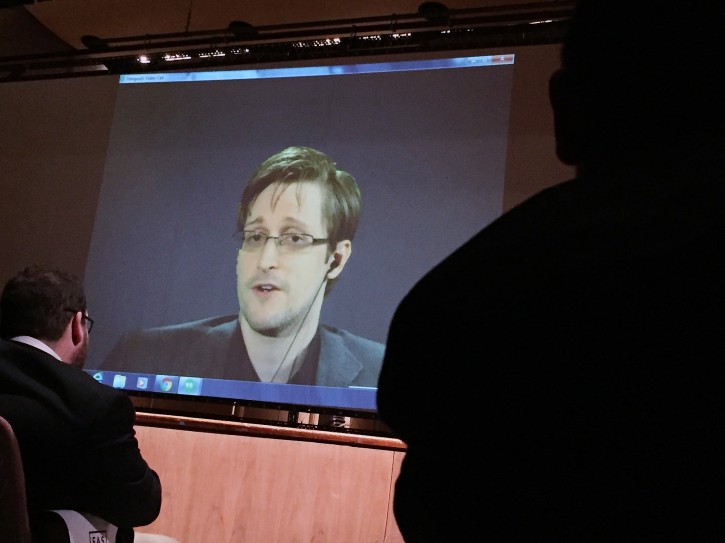 Former National Security Agency contractor Edward Snowden, center speaks via video conference to people in the Johns Hopkins University auditorium, Wednesday, Feb. 17, 2016, in Baltimore. Hopkins students spent months arranging the live video conference Wednesday night with Snowden, according to the Baltimore Sun. (AP Photo/Juliet Linderman)