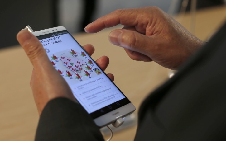A man checks the Huawei Honor 5X during Mobile World Congress wireless show in Barcelona, Spain, Tuesday, Feb. 23, 2016. Along with other Chinese phone makers such as Huawei and Xiaomi, Chinese brands have surpassed Samsung in China and are encroaching on Apples turf. (AP Photo/Manu Fernandez)