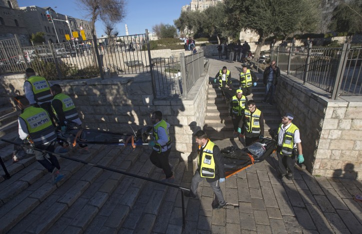 Israeli medicals carrying the bodies of three  Palestinian attackers, next to Damascus gate of the old city of Jerusalem, 03 February 2016. EPA