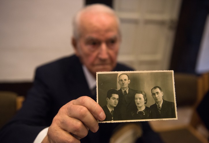 Auschwitz concentration camp survivor Leon Schwarzbaum presents an old photograph showing himself (L) next to his uncle and parents who all died in Auschwitz, during a press conference inÂ Detmold, Germany, 10 February 2016. EPA