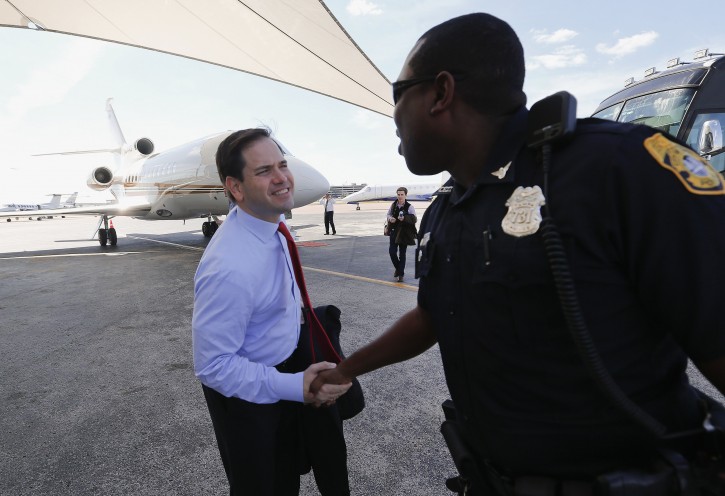 Republican presidential candidate, Sen. Marco Rubio, R-Fla., shakes hands with a police officer after arriving in Tampa, Fla., Monday, March 7, 2016. (AP Photo/Paul Sancya)