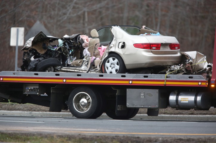 A vehicle is towed away after a fatal accident on Route 9 near Route 516 in Old Bridge, N.J., Tuesday, March 15, 2016. Authorities say a two-vehicle crash on a major New Jersey roadway has left multiple people dead and others seriously injured. (John O'Boyle /NJ Advance Media via AP)  
