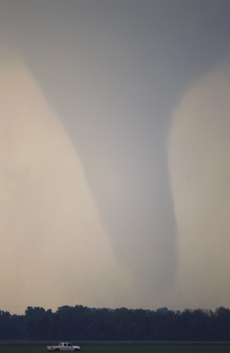 FILE - In the April 14, 2012 file photo, a truck drives along I-70 as a tornado moves on the ground north of Soloman, Kansas. AP