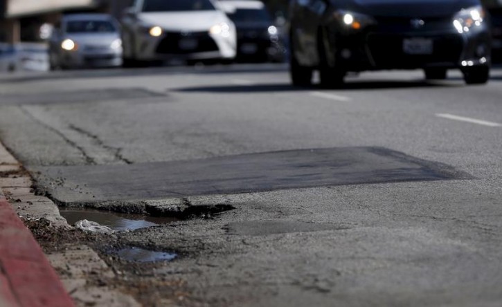 A pothole is pictured on the street of Los Angeles, California February 12, 2016. An estimated 65 percent of U.S. roads are in poor condition, according to the U.S. Department of Transportation, with the transportation infrastructure system rated 12th in the World Economic Forum's 2014-2015 global competitiveness report. Picture taken February 12. REUTERS