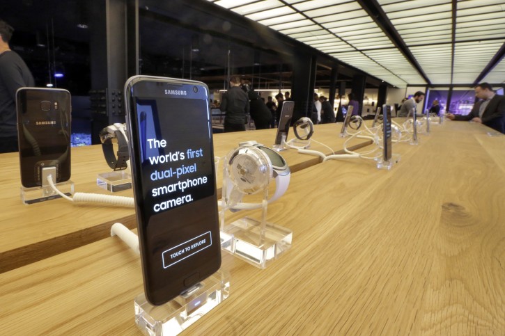 A table of Samsung Galaxy S7 and S7 Edge mobile phones and smartwatches line a table in Samsung's flagship store, Samsung 837, in New York's Meatpacking District, Monday, Feb 22, 2016. Samsung is opening what it calls a "technology playground" in New York for customers to check out its latest gadgets. The center opens Tuesday, the day Samsung starts taking orders for its upcoming Galaxy S7 and S7 Edge phones. (AP Photo/Richard Drew)