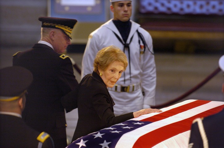 FILE -  Nancy Reagan pauses to look back and touch the coffin of her late husband, former President Ronald Reagan, as the coffin is prepared to depart the US Capitol Rotunda for a funeral service at the Washington National Cathedral, Friday 11 June 2004.  EPA