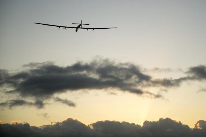 The Solar Impulse 2 solar plane flies into the sunrise out of Kalaeloa Airport, Thursday, April 21, 2016, in Kapolei, Hawaii. The solar plane will fly a two-and-a-half day journey to Northern California. (AP Photo/Marco Garcia)