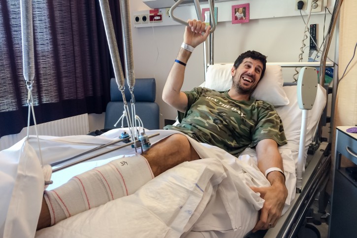 In this photo taken on Sunday, April 3, 2016, Belgian professional basketball player Sebastien Bellin rests in his bed in Erasmus University Hospital in Brussels. Sebastien Bellin, a 6-foot-9 giant once celebrated for his skills on the basketball court, is today better known as the man who was photographed lying bloody on the floor of Brussels main airport after the March 22 bombings. (AP Photo/Helene Franchineau)