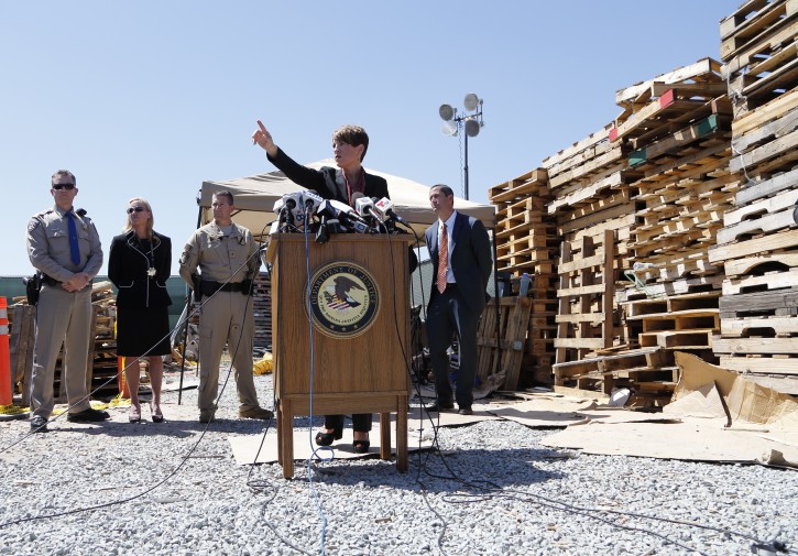 U.S. Attorney Laura Duffy speaks during a news conference in a lot alongside the border with Mexico Wednesday, April 20, 2016, in San Diego. A nearly half-mile-long tunnel leading from Mexico to San Diego was discovered and more than a ton of cocaine and seven tons of marijuana was seized, the U.S. attorney's office said Wednesday. Six people were arrested. (AP Photo/Gregory Bull)