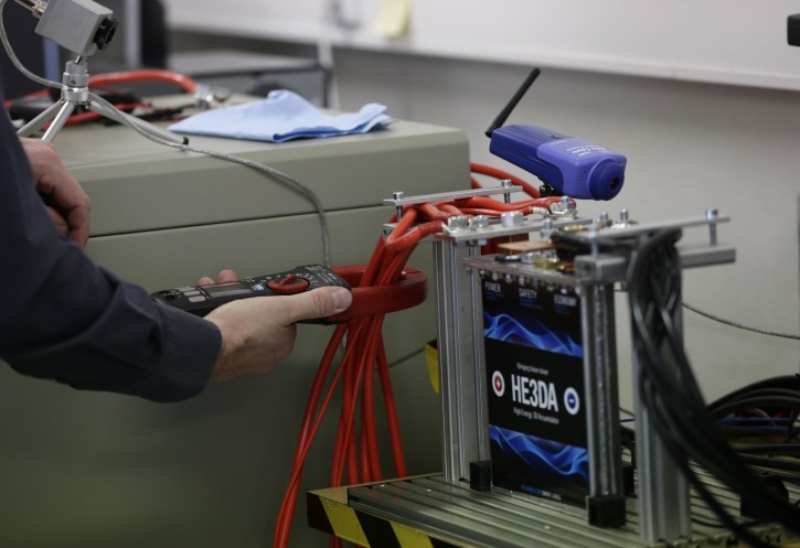 In this picture taken on Wednesday, March 9, 2016, a worker tests a battery at the Prague based He3Da company, in the Czech Republic. (AP Photo/Petr David Josek)