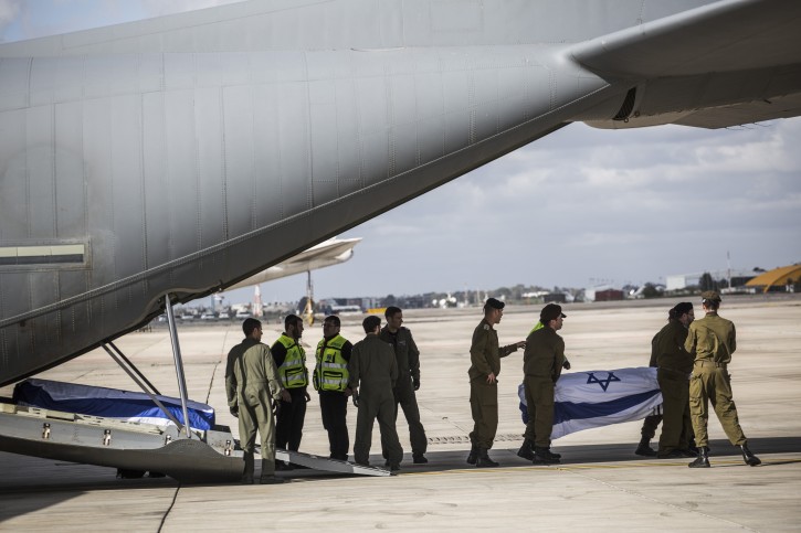 Israeli soldiers and medical workers carry a coffin of a killed Israeli upon arrival at Ben Gurion Airport, Israel, on March 20, 2016. Flash90 