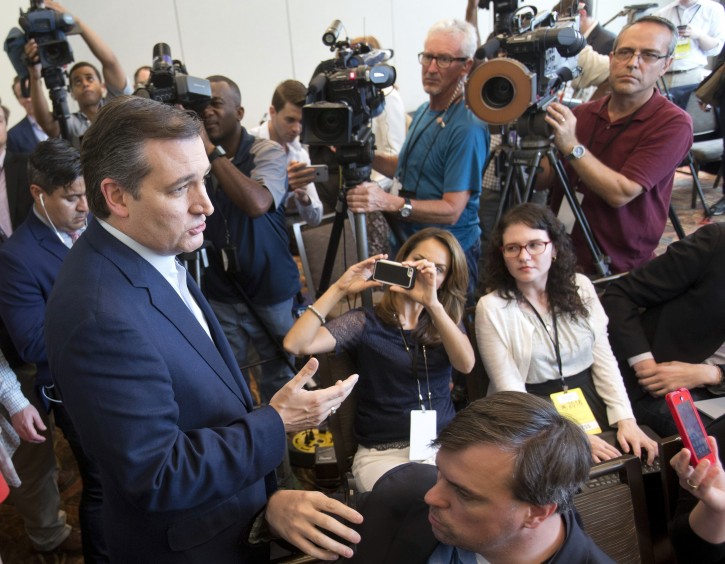Republican presidential candidate Sen. Ted Cruz, R-Texas, left, talks to media members as he leaves a news conference, Wednesday, April 20, 2016, at the Republican National Committee Spring Meeting in Hollywood, Fla. (AP Photo/Wilfredo Lee)