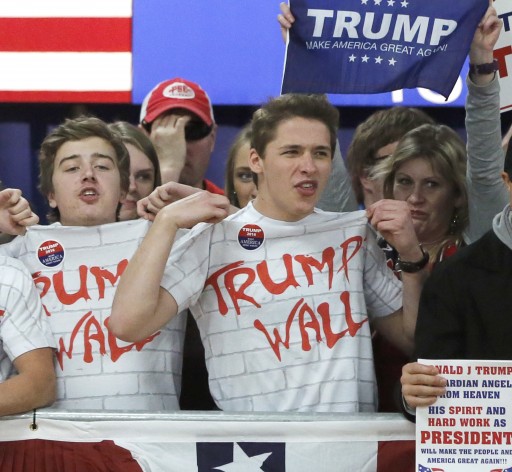 Supporters of Republican presidential candidate, Donald Trump, chant, Build That Wall, before a town hall Saturday, April 2, 2016, in Rothschild, Wis. (AP Photo/Charles Rex Arbogast)