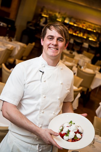 Chef Edward Boarland holding one of the dishes prepared in the VIN cooking is Eton mess, a traditional English dessert consisting of a mixture of strawberries or bananas, pieces of meringue, and cream.  (Lenchevsky Images)