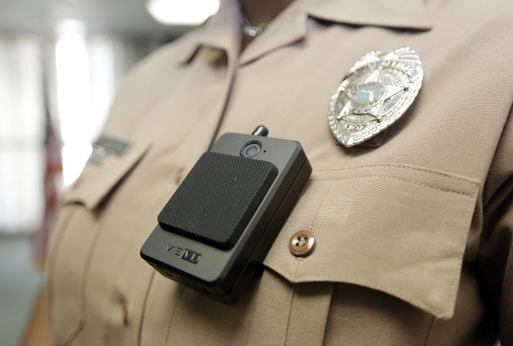 A body camera is worn by Miami-Dade Police Department PIO Marjorie Eloi, which 1,000 officers will begin using over the next few months, during a news conference, Thursday, April 28, 2016, in Doral, Fla. Police body cameras have become more popular following a number of controversial officer shootings around the country. (AP Photo/Lynne Sladky)
