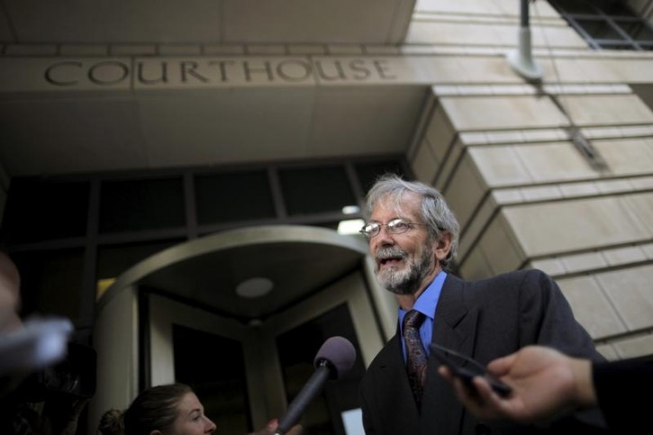 FILE - Douglas Hughes talks to reporters outside of a courthouse in Washington June 22, 2015. REUTERS