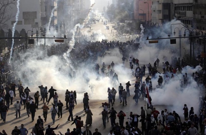 FILE - Protesters flee from tear gas fire during clashes in Cairo January 28, 2011. Reuters