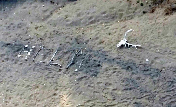 This aerial photo taken Saturday, April 9, 2016, and provided by Arizona Department of Public Safety shows, a "help" sign made by Ann Rodgers, 72, in the White Mountains of eastern Arizona. Rodgers got lost after her hybrid car ran out of gas and battery on March 31. (Arizona Department of Public Safety via AP)