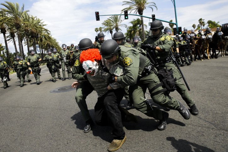 Orange County Sheriff's deputies arrest a protester outside the Anaheim Convention Center where Republican presidential candidate Donald Trump held a rally, Wednesday, May 25, 2016, in Anaheim, Calif. (AP Photo/Jae C. Hong)