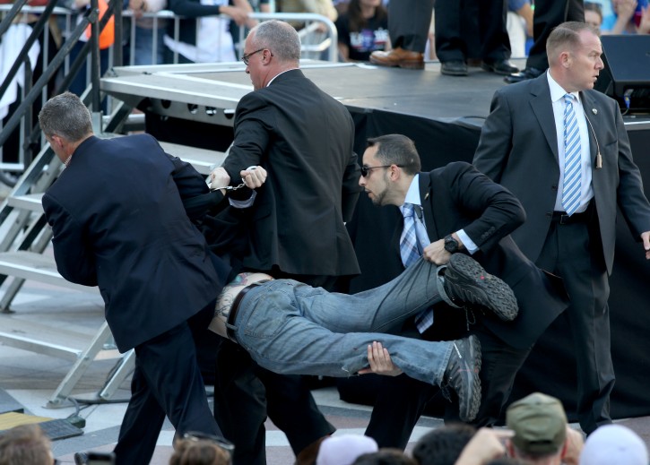 Secret Service agents remove a man from the crowd during a campaign rally for Democratic presidential candidate, Sen. Bernie Sanders, I-Vt., at Frank Ogawa Plaza in Oakland, Calif., on Monday, May 30, 2016. (Anda Chu/Oakland Tribune via AP)