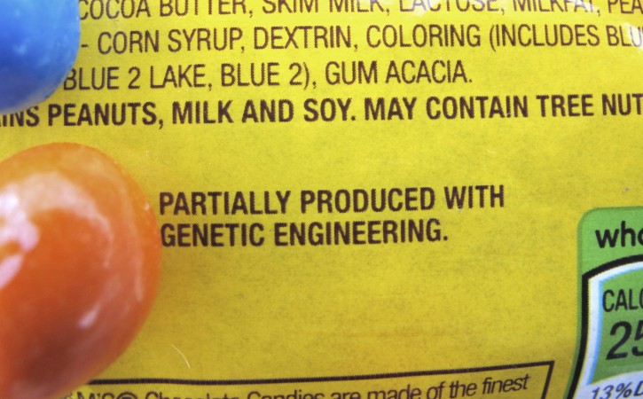 FILE - In this April 8, 2016 file photo, a new disclosure statement is displayed on a package of Peanut M&M's candy in Montpelier, Vt., saying they are "Partially produced with genetic engineering." Genetically manipulated food remains generally safe for humans and the environment, a high-powered science advisory board declared in a report Tuesday, May 17, 2016. (AP Photo/Lisa Rathke, File)