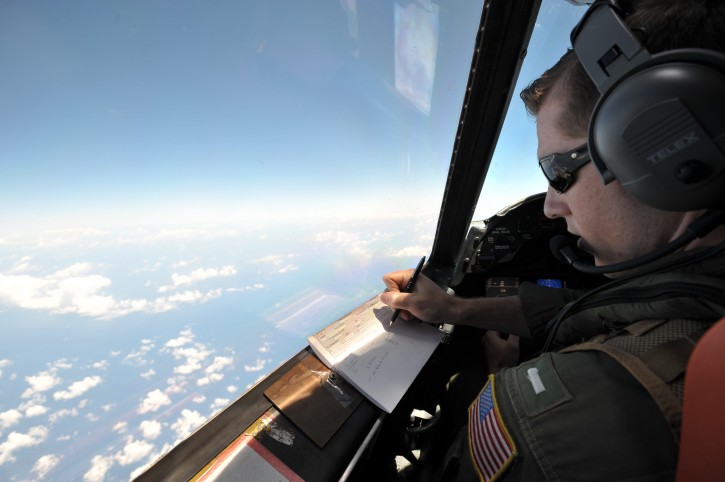U.S. Navy LT JG Curtis Calabrese takes notes on board of a U.S. Navy Lockheed P-3C Orion patrol aircraft from Sigonella, Sicily, Sunday, May 22, 2016, searching the area in the Mediterranean Sea where the Egyptair flight 804 en route from Paris to Cairo went missing on May 19. Search crews found floating human remains, luggage and seats from the doomed EgyptAir jetliner Friday but face a potentially more complex task in locating bigger pieces of wreckage and the black boxes vital to determining why the plane plunged into the Mediterranean. (AP Photo/Salvatore Cavalli)