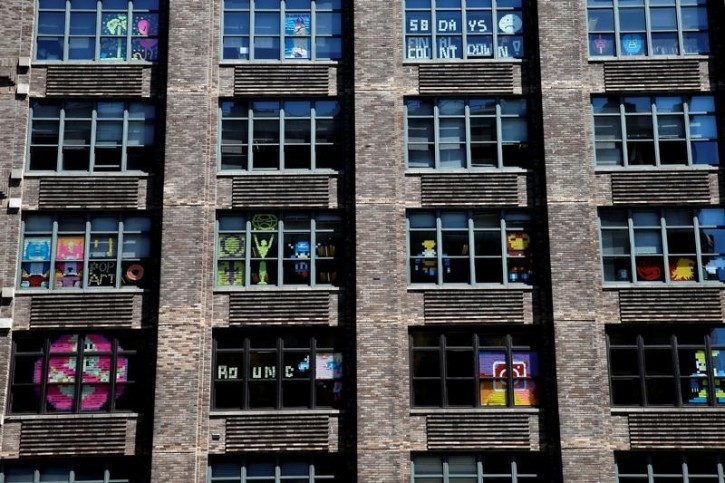 Images created with Post-it notes are seen in the windows of offices at 75 Varick Street in lower Manhattan, New York, U.S., May 18, 2016, where advertising agencies and other companies have started what is being called a "Post-it note war" with employees creating colorful images in their windows with Post-it notes. REUTERS/Mike Segar 