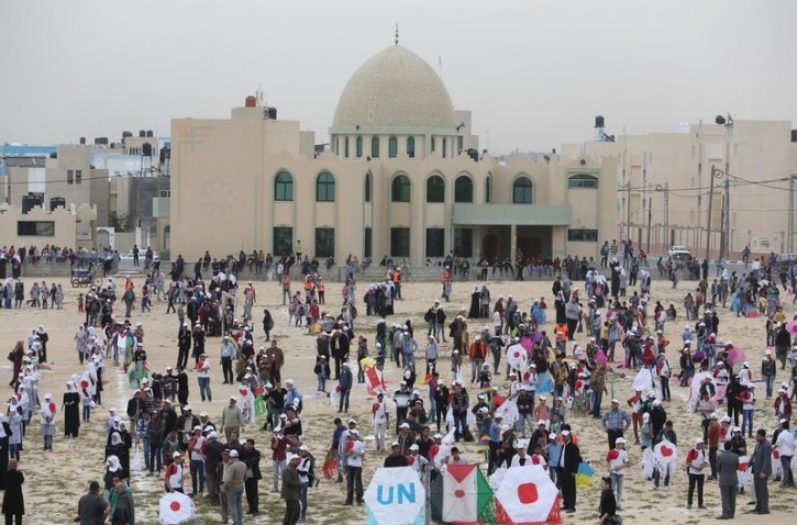 FILE - Palestinian school children prepare to fly kites to show solidarity with the Japanese people, near the Japan-funded housing project in Khan Younis in the southern Gaza Strip March 13, 2016. Reuters