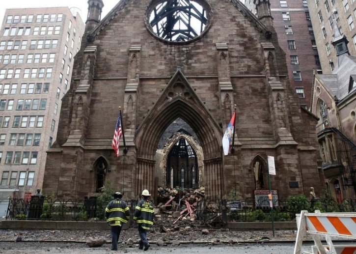 New York City firefighters (FDNY) walk through the debris following a fire at Manhattan's historic Serbian Orthodox Cathedral of Saint Sava in New York City, U.S., May 2, 2016. REUTERS/Brendan McDermid 