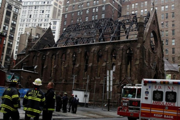 New York City firefighters (FDNY) stand in front of Manhattan's historic Serbian Orthodox Cathedral of Saint Sava following a fire in New York City, U.S., May 2, 2016. REUTERS/Brendan McDermid 